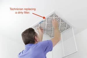 hvac technician replacing a dirty air filter