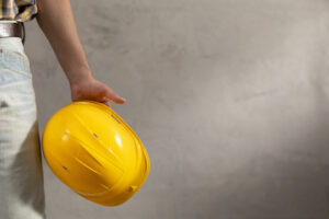 hired concrete contractor holding construction helmet