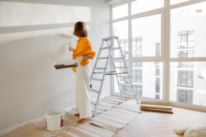 woman painting home interior for flawless finish