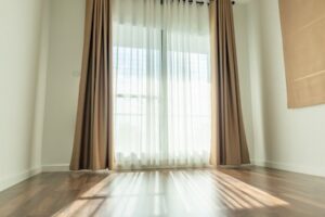 Elevate Your Window Treatments By Hanging Curtains Over Blinds
